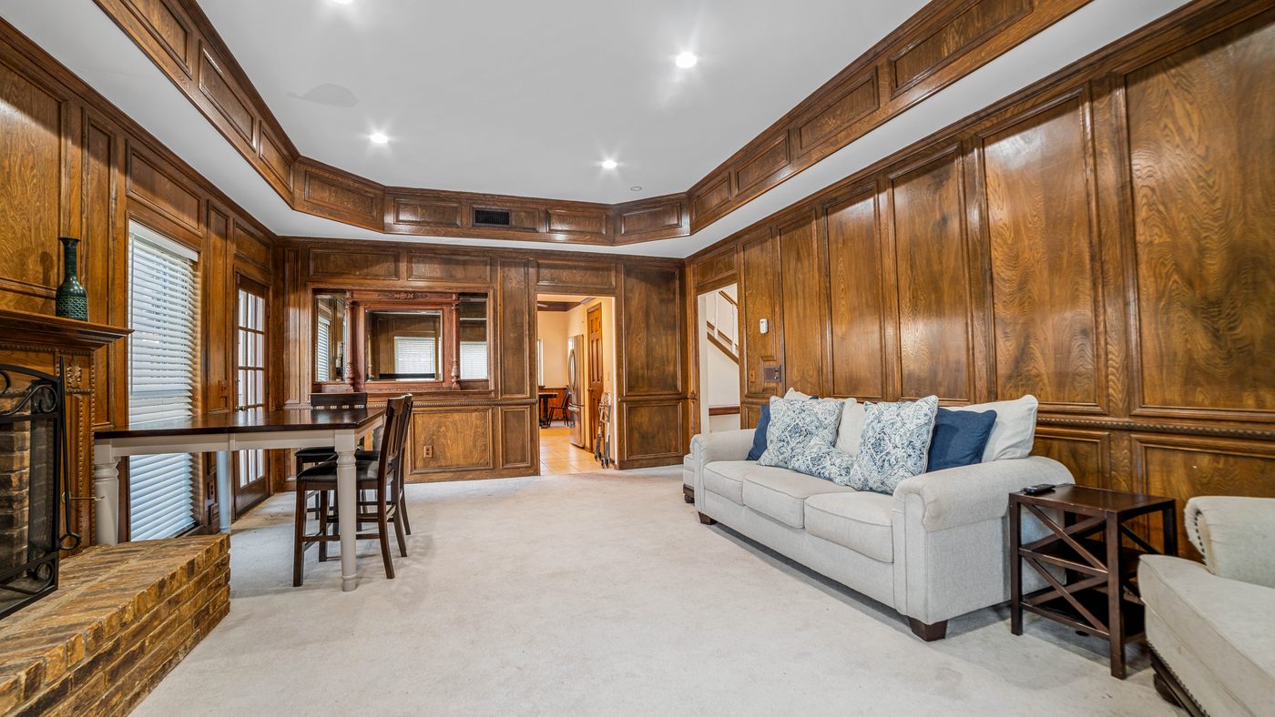 Wood-paneled living room with sofa and recessed lights at Baffin Bay