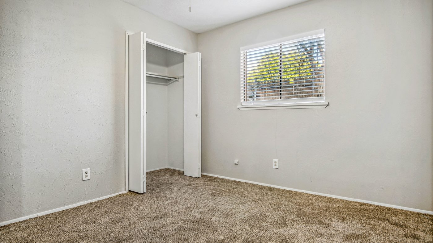 Carpeted bedroom with closet and window at Blue Ridge