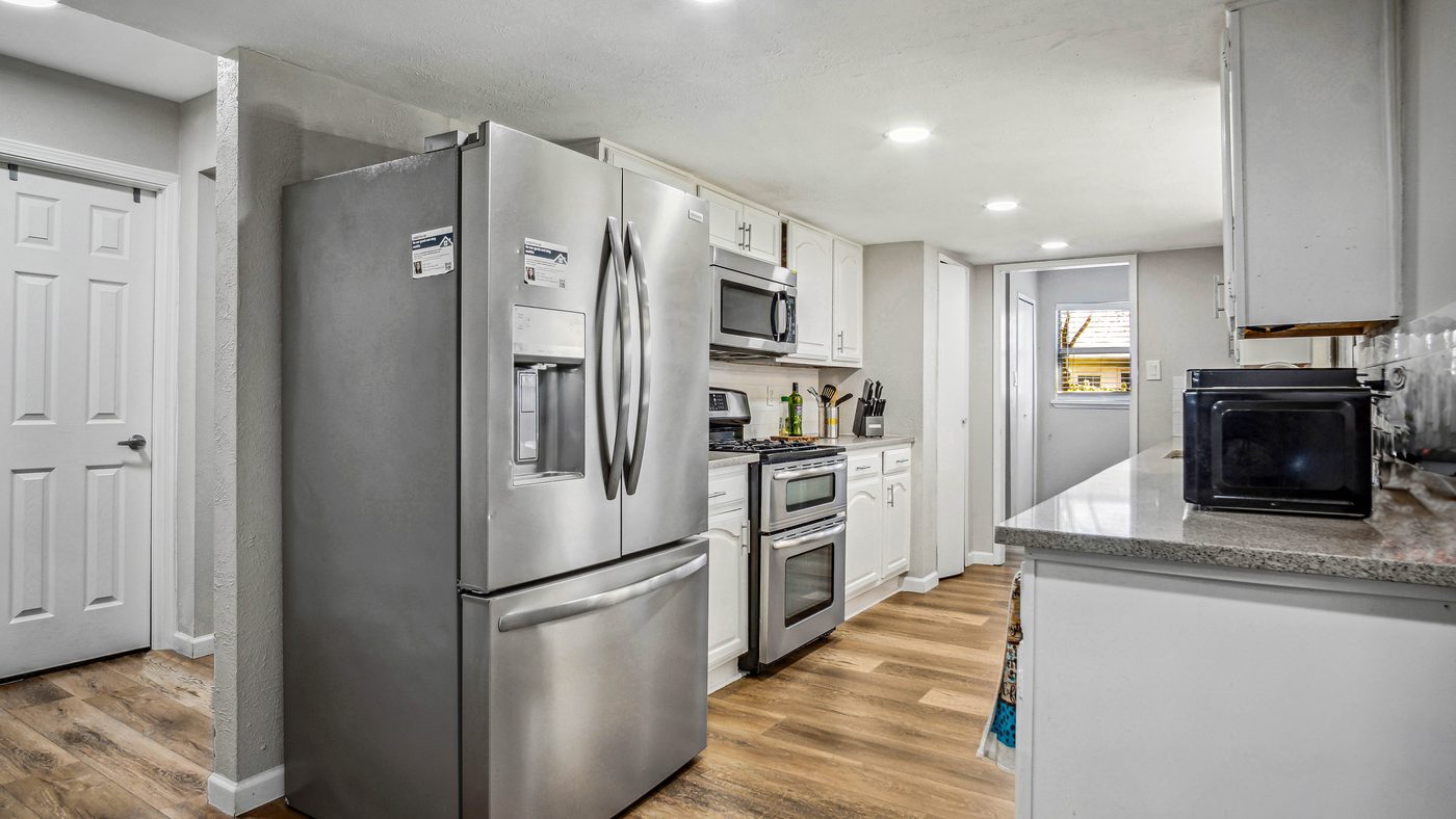 Kitchen with stainless appliances and white cabinets at Blue Ridge