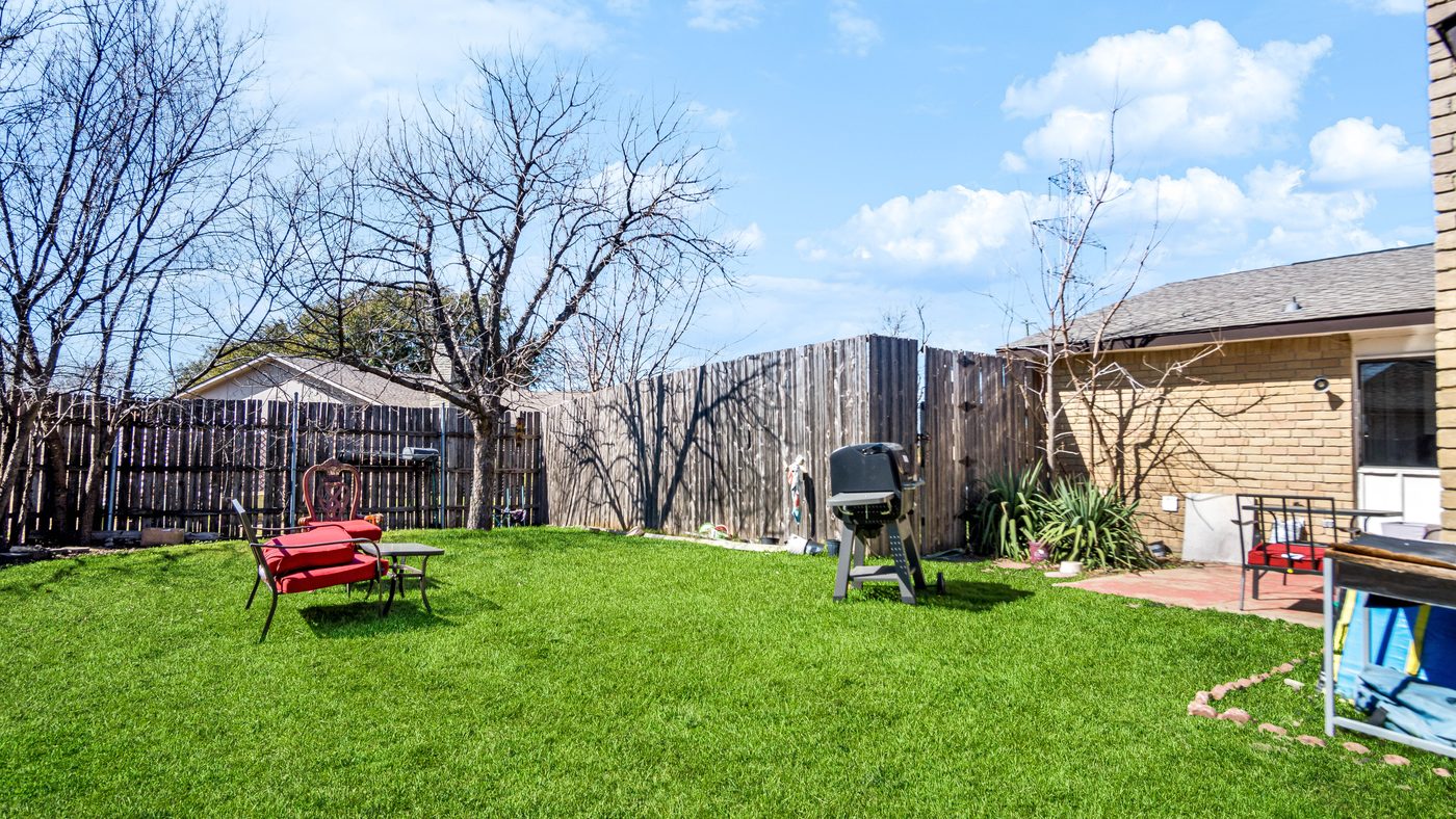 Fenced backyard lawn at Chinaberry
