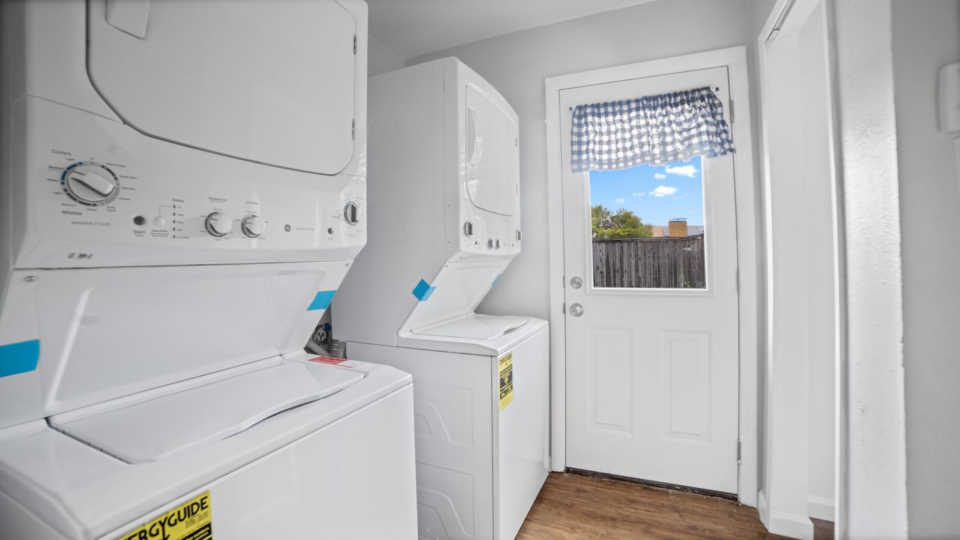 Laundry area with stacked washers and dryers at John Muir