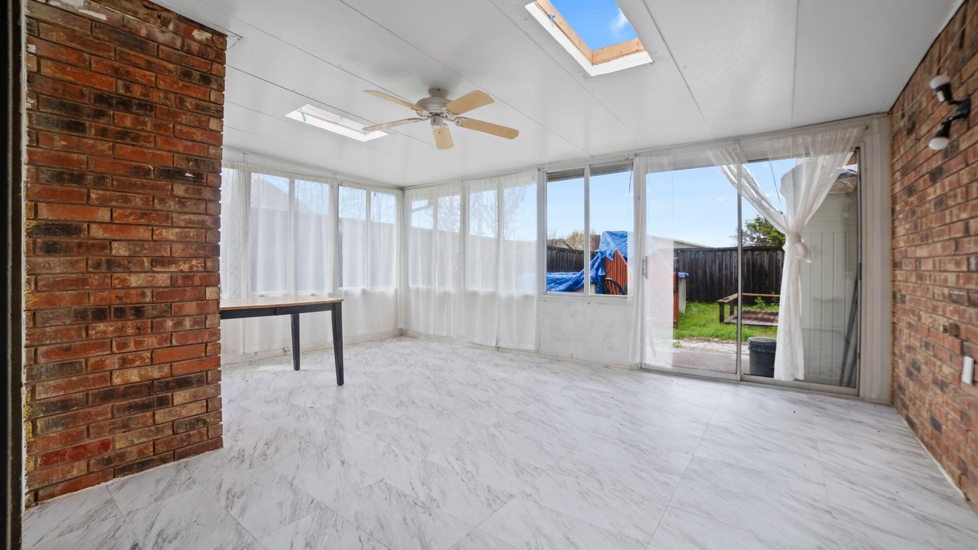 Sunroom with brick walls and skylight at John Muir