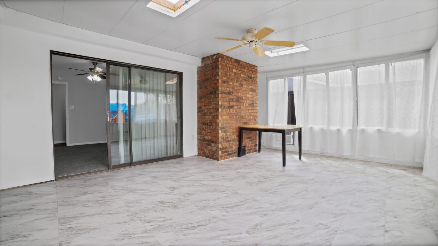 Sunroom with sliding doors and a table at John Muir