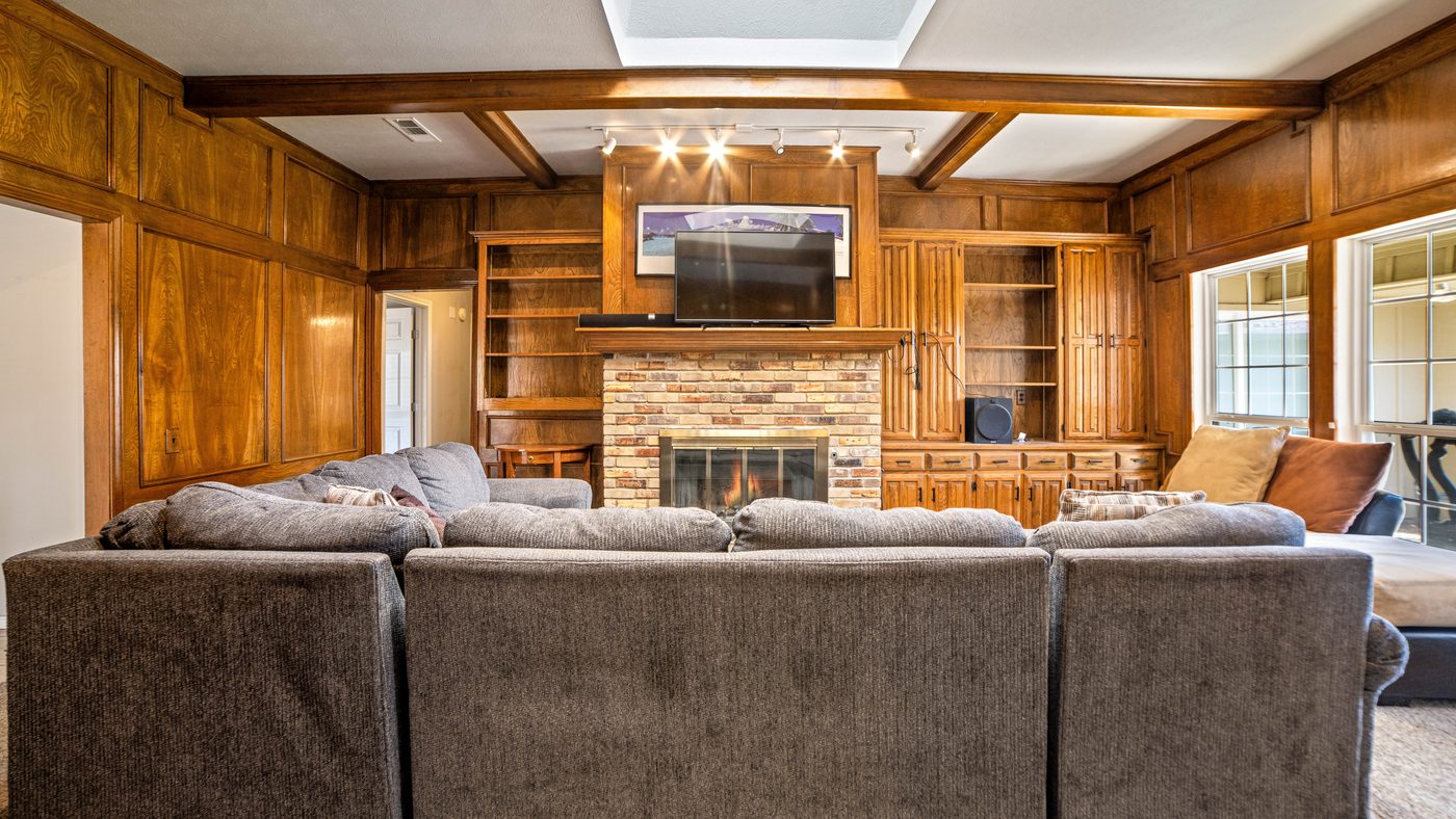 Living room with sectional sofa, fireplace and built-in shelves at Matterhorn