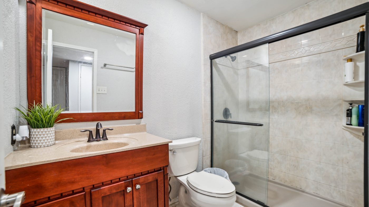 Bathroom with wood vanity and glass shower at Overdowns