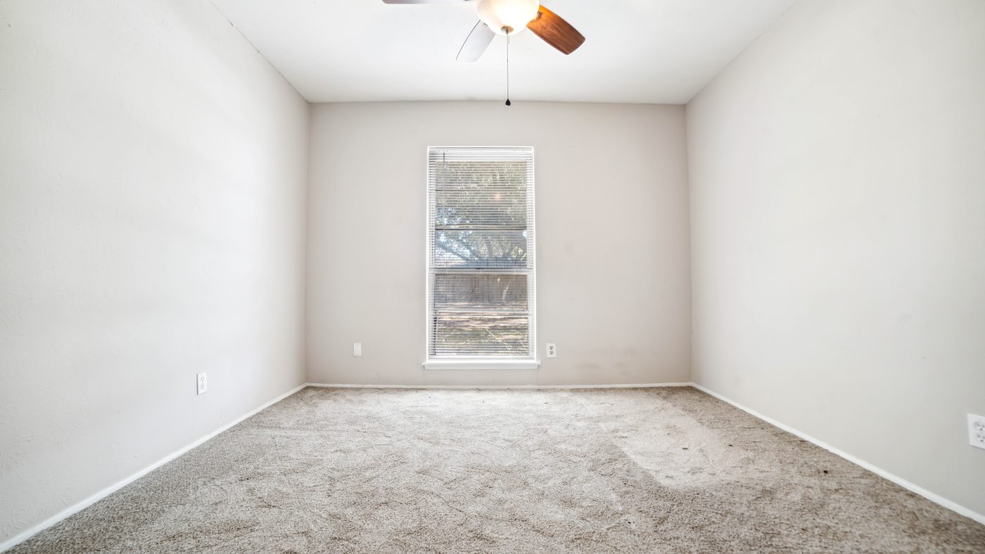 Carpeted bedroom with window and ceiling fan at Overdowns