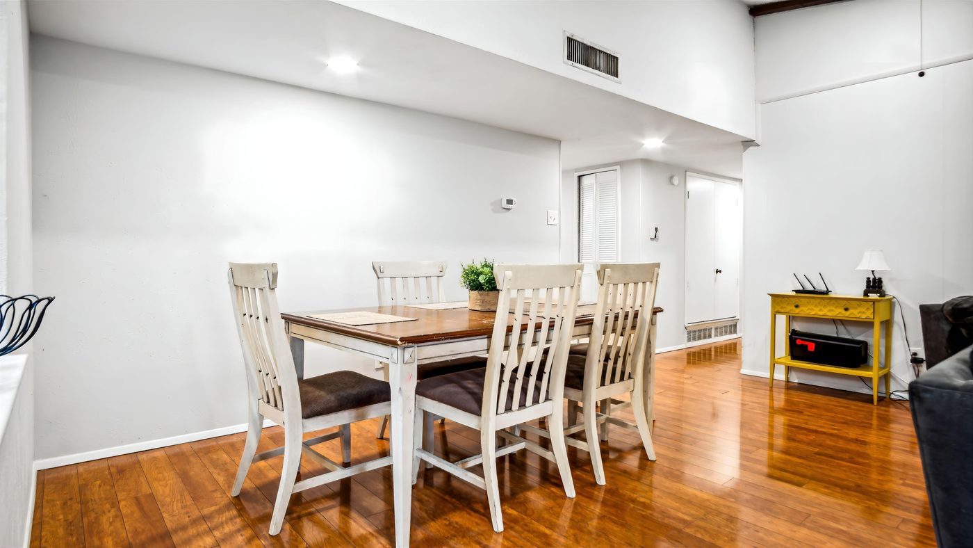 Dining table with white chairs at Overdowns
