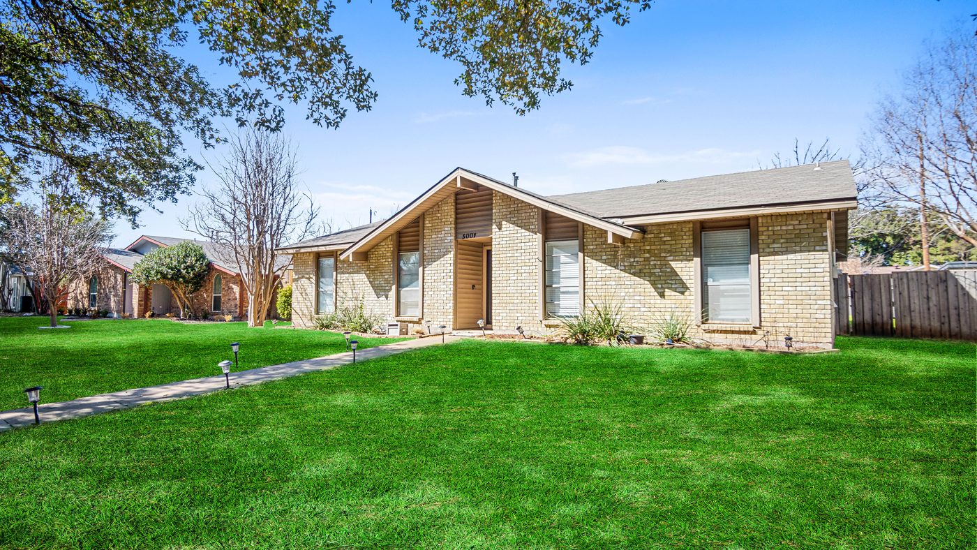 Brick front of Overdowns with a peaked entry and lawn