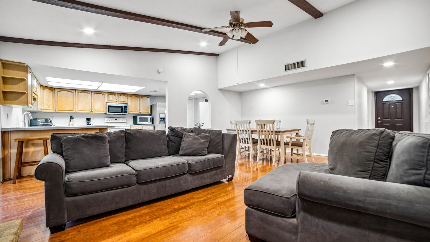 Open living room with sofas and hardwood floor at Overdowns