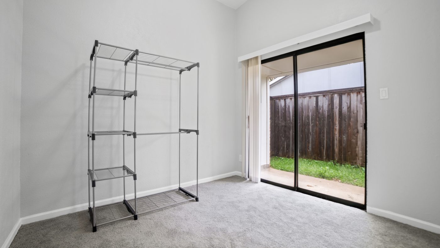 Example bedroom with sliding glass door and garment rack, shown for Spring Creek