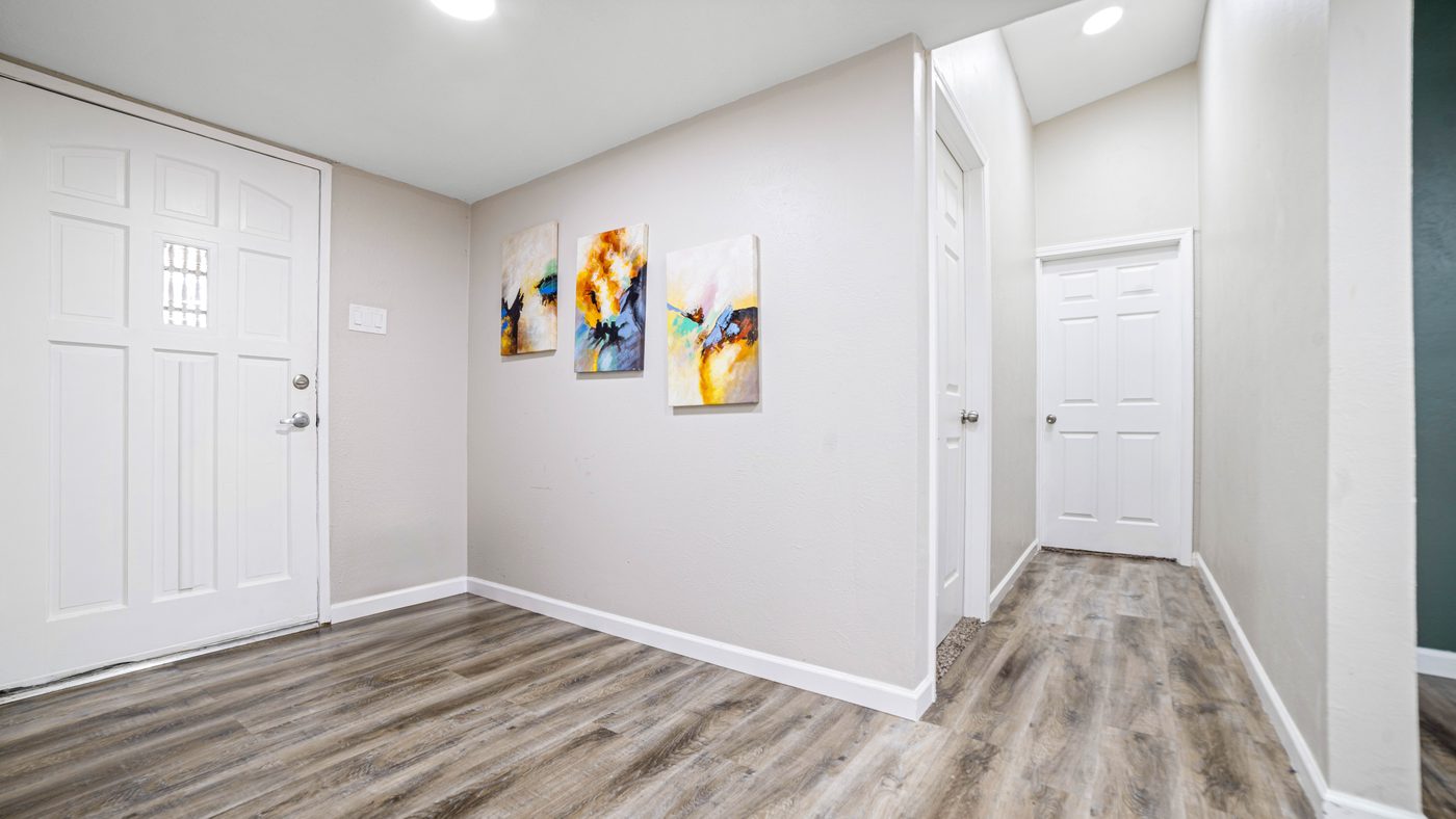 Entry with wood-look floor and wall art at Spring Creek
