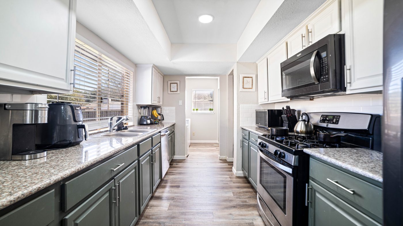 Kitchen with gas range and stainless microwave at Spring Creek