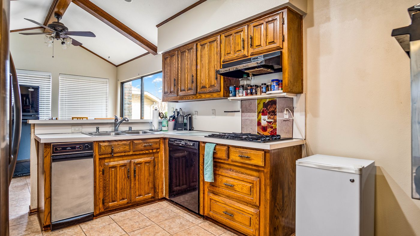 Kitchen with wood cabinets and vaulted ceiling at Stain Glass