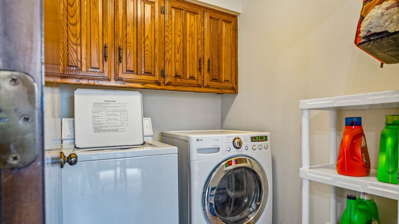 Washer and dryer with wood cabinets at Stain Glass