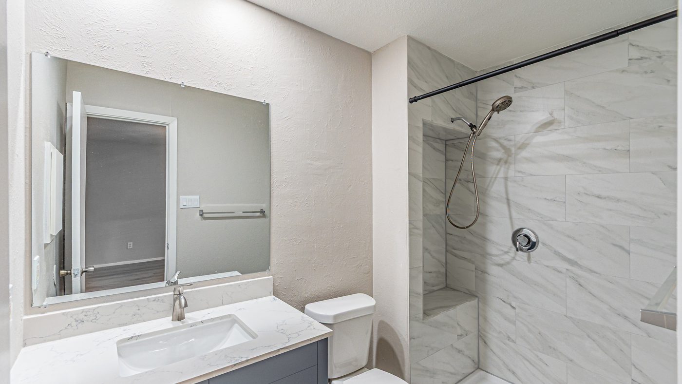 Bathroom with walk-in shower and white vanity at Yosemite