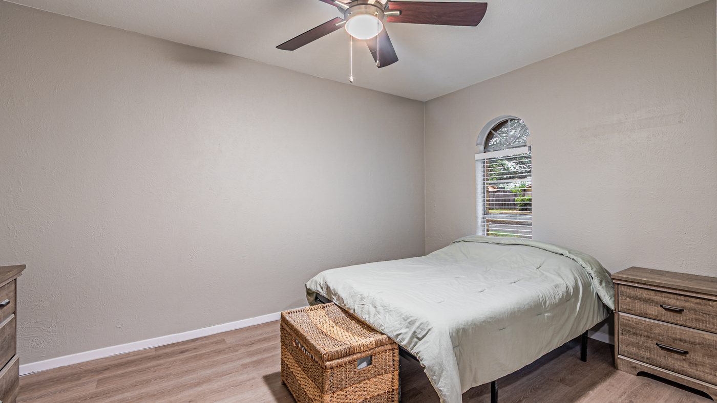 Bedroom with bed and arched window at Yosemite